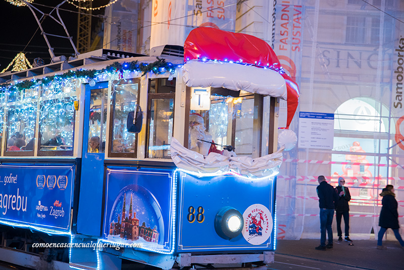 zagreb navidad. Imagen un tranvía azul conducido por papa noel. La bina del conductor tiene un sombreo y una pequeña barba de papa noel.tor